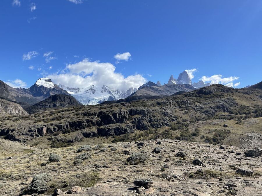 Snowy granite spires rising behind a rocky plateau