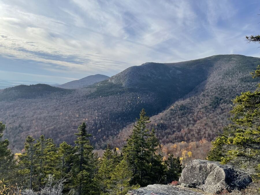 The same autumn range under long streaks of cloud