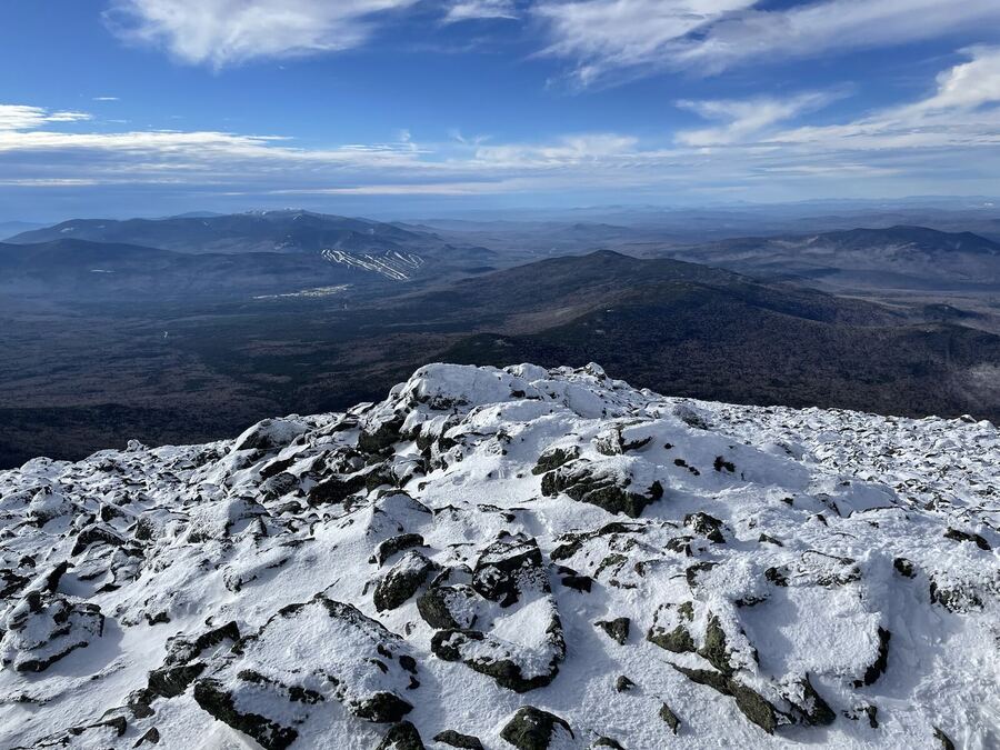 A snowy summit looking out across blue ranges